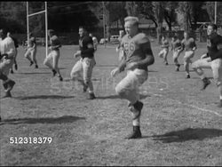 1952: WASHINGTON & JEFFERSON COLLEGE FOOTBALL TRAINING: VS Hand snapping football, W&J College football team on field training, performing various exercise drills, coach Joe McMullen coaching center Stan Hoover to properly snap, feet kicking ball. Instructional Video