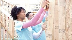 Diverse volunteers building home for charitable organization Stock Footage