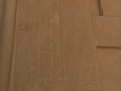 Tilt down stone wall engraved with ancient Egyptian hieroglyphics, Sakkara, Egypt (sound available) Stock Footage