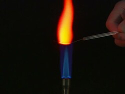 A flame test used in chemistry to detect the presence of certain metal ions, based on each elements characteristic emission spectrum (Sodium Nitrate) Stock Footage