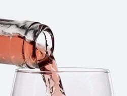 CU SLO MO Shot of Pink wine being pour into glass against white background / Calvados, Normandy, France Stock Footage