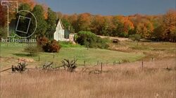 Static shot of a field and a country home in the countryside Stock Footage