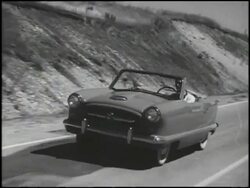 1954 Nash Metropolitan driving on test track Stock Footage