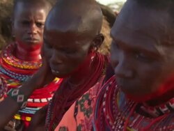 Maasai Ceremony - Women apply red face paint in preparation for ceremony, WITH AUDIO Stock Footage