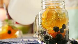 Infused Water with Fresh Blueberries and Oranges Stock Footage