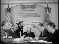 1941: THE FREE FRENCH: MS Female hands stuffing 'France Forever' brochure into envelope. Men in suits around table w/ 'O Star of France' Walt Whitman poem BG. MS woman putting brochure into envelope. Display of  Charles de Gaulle's books Instructional Video