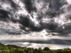 Sunbeam and clouds motion passing over at lake Stock Footage