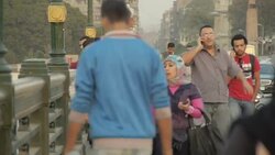 Pedestrians crossing Tahrir Bridge at dusk News Clip