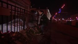 People laying flowers in front of US embassy to pay tribute to killed at school News Clip