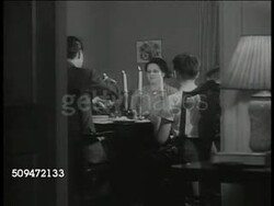 1939: U.S. FAMILY DINING: EXT MS Two story house. INT MS Above-average family eating at dinner table. MS Boys (sons) eating. MS Little girl eating. Lifestyle, supper. Americana Instructional Video