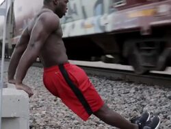 MS Young man working out his arms while exercising  near  train track / Minneapolis, Minnesota, United States Stock Footage