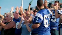 Stadium crowd cheers at football game, various high-fives Stock Footage