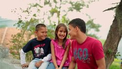 Hispanic teenage brother makes younger siblings laugh Stock Footage