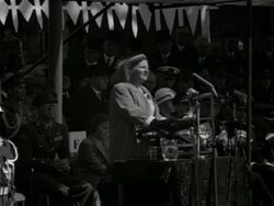 Queen Juliana gives a speech on the occasion of Liberation Day. After the speech there is a parade of Dutch, French and American soldiers. In Amsterdam a Liberation fire is ignited Stock Footage