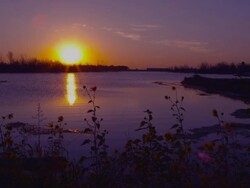 Dolly shot of sunset overlooking a lake in Nebraska. Stock Footage