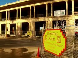 CU, ZO, MS, Freight train moving behind abandoned hotel, Needles, California, USA Stock Footage
