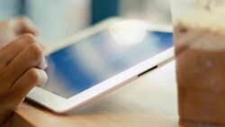 Woman hand using digital tablet at coffee cafe Stock Footage