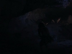 Prehistoric man cooking food over a fire. Stock Footage