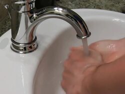 Washing Hands in Bathroom Sink Stock Footage