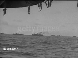 1942: UNITED STATES COAST GUARD: WS Convoy of ships on horizon line. MS Signalman hand flashing code on signal lamp. (Grainy) US Warship on rough sea. VS On ship in bad weather, men on deck, man in Crow's Nest.  WWII, World War II. Instructional Video