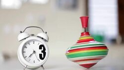 Alarm Clock and Spinning Top on the table Stock Footage