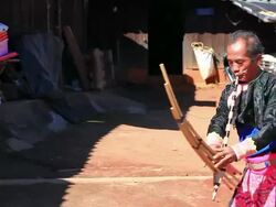 HD:Karen man in traditional costumes playing a flute. Stock Footage