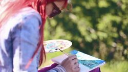 Young woman painting landscape in open air Stock Footage