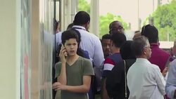 CLEAN : UAE: people flock to Qatar Airways office as flight ban begins News Clip