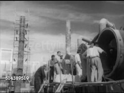 1952: KUWAIT: WATER PURIFICATION PLANT: Angled WS Structure under construction, men standing on scaffold checking interior of large pipes, man sorting & attaching hoses to metal container.     Desalination, profits from oil, sheikh, ministry. Instructional Video