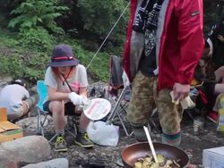 MS PAN Shot of friends make fire for cooking food at camping / Okutama, Tokyo, Japan Stock Footage