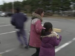 Aftermath of tsunami after magnitude 9 Tohoku earthquake, north east Japan, March 2011. People gather supplies at tofu factory in Osaki city after tsunami Stock Footage