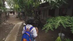 W/S STEADYCAM motion, Burmese teenage girl arriving to home from school, back Stock Footage