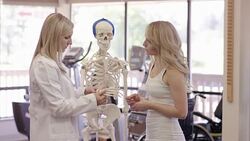 Physical therapist working with young adult female Stock Footage