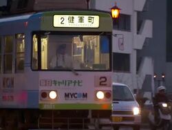 Medium pan-left pan-right zoom-out - A bus driver makes a right-hand turn onto a busy city street. / Kumamoto, Japan Stock Footage