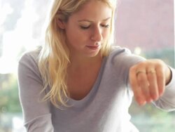 Female in kitchen preparing food looking into pan Stock Footage
