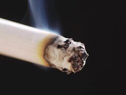 Burning cigarette isolated on black Stock Footage