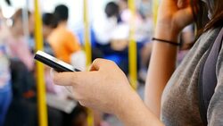 Woman use social media for communication in the sky train Stock Footage