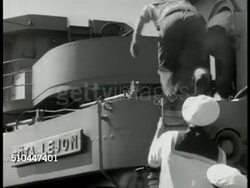 1949: SWEDEN DEFENSES: VS Royal Swedish Navy sailors running on deck to stations, Patrol Torpedo (PT) Boat in water, sailors climbing ladder to stations, PT Boat. LA WS Manning anti-aircraft cannons. WS Convoy at sea. WS Sentries standing on fort. Instructional Video