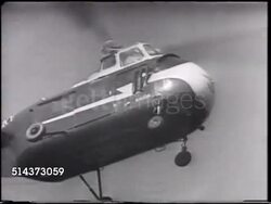 1950: SIKORSKY HELICOPTER: BEHIND Men standing watching H-19 Chickasaw multipurpose transport chopper lifting off, MS Igor Sikorsky looking upward, TU WS Chopper in flight, turning, large curved turn, moving left. Instructional Video