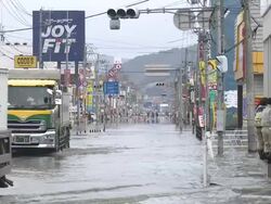 Destruction caused by tsunami after magnitude 9 Tohoku earthquake, north east Japan, March 2011. Trucks drive through tidal flooding in Ishinomaki, Miyagi Prefecture after tsunami Stock Footage