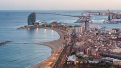 Elevated dusk view over Barcelona beaches and seaport, Barcelona, Catalunya, Spain - Time lapse Stock Footage