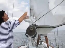 couple put main sail up on yacht /tampa,florida,USA Stock Footage