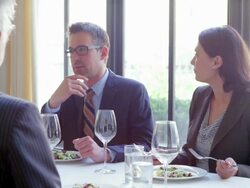 MS business people sitting in discussion during lunch meeting at table in restaurant. Stock Footage