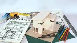 Architects workspace with house model & blue print Stock Footage