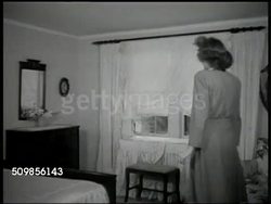 1946: SUBURBAN NEIGHBORHOOD: HA WS Suburban neighborhood w/ children on sidewalk. WS Home. Social Worker doing home inspection w/ childless couple (30s), walking upstairs into nursery, female hand writing on Application for Adoption paper. Instructional Video