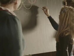 CU TS Shot of teacher giving crayon to girl in front of blackboard / Grossweil, Bavaria, Germany  Stock Footage