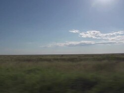 Tracking shot of clouds over grasslands Stock Footage
