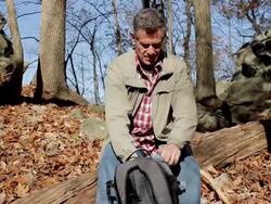 MS TD Man pouring hot drink and resting on log during hike / Clinton, New Jersey, USA Stock Footage