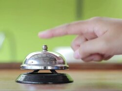 female hand ringing silver service bell,Close-up Stock Footage