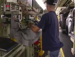 MS PAN TS Worker using lift arm to help him installing  seat in minivan chassis / Princeton, Indiana, United States Stock Footage